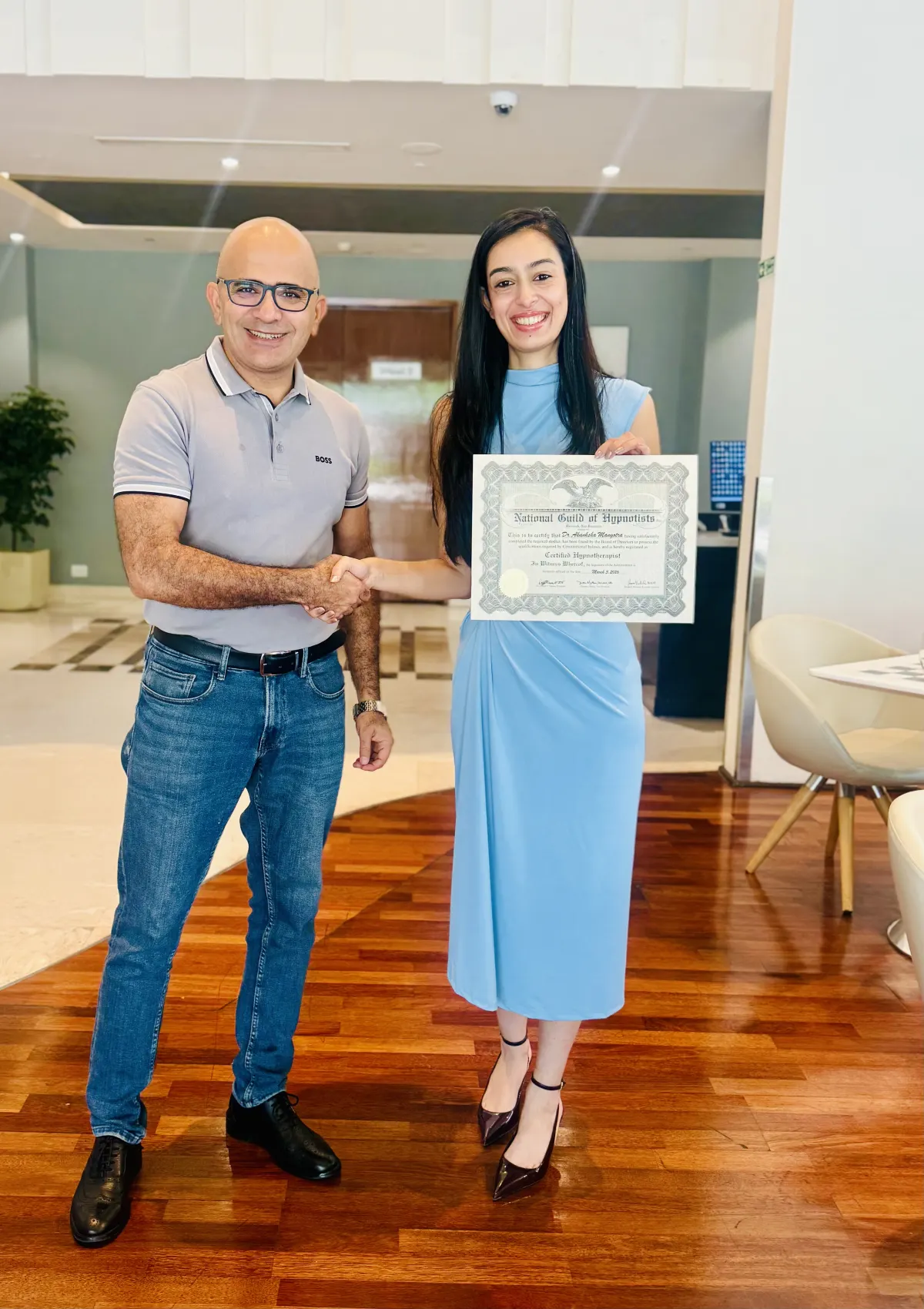 Dr. Akanksha Mangotra receiving her Certified Hypnotherapist certificate from the National Guild of Hypnotists (USA), presented by her trainer Dr. Maruti Sharma.